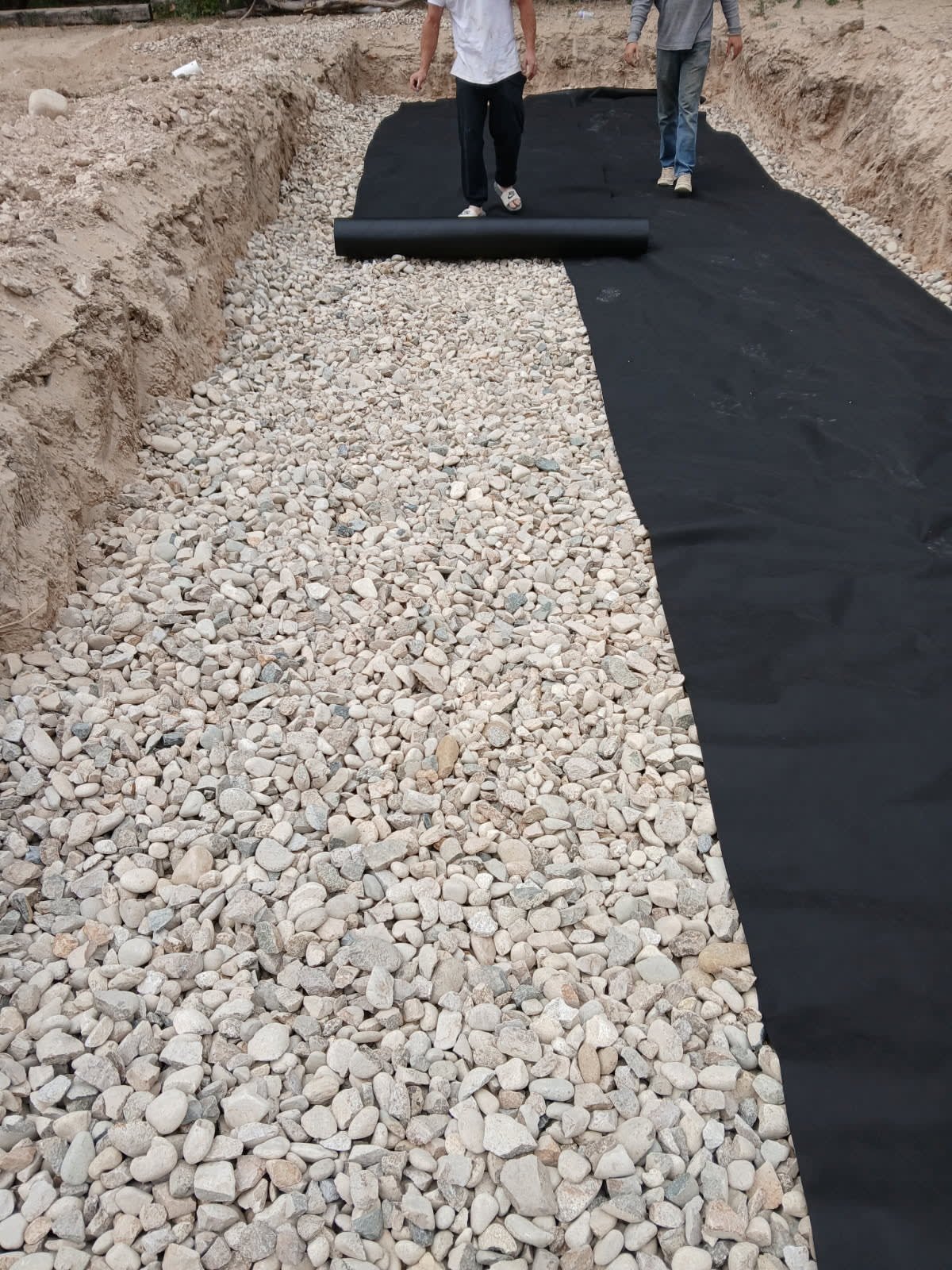 Septic drainfield bed prepped with washed gravel and filter fabric